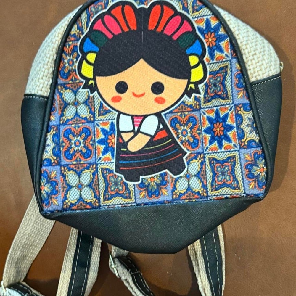 Kawaii backpack with cartoon girl graphic featuring colorful geometric pattern